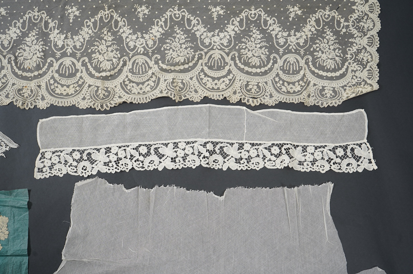 A late 19th century Brussels bobbin lace on net section of a wedding veil, Brussels bobbin lace collar, a point de gaz lace motif and two lengths of later bobbin lace trimming possibly Honiton with needle lace insertions